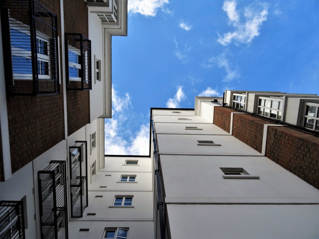 Low angle view of contemporary buildings and sky, showcasing urban architectural design.